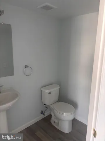 a white toilet sitting next to a bathroom sink