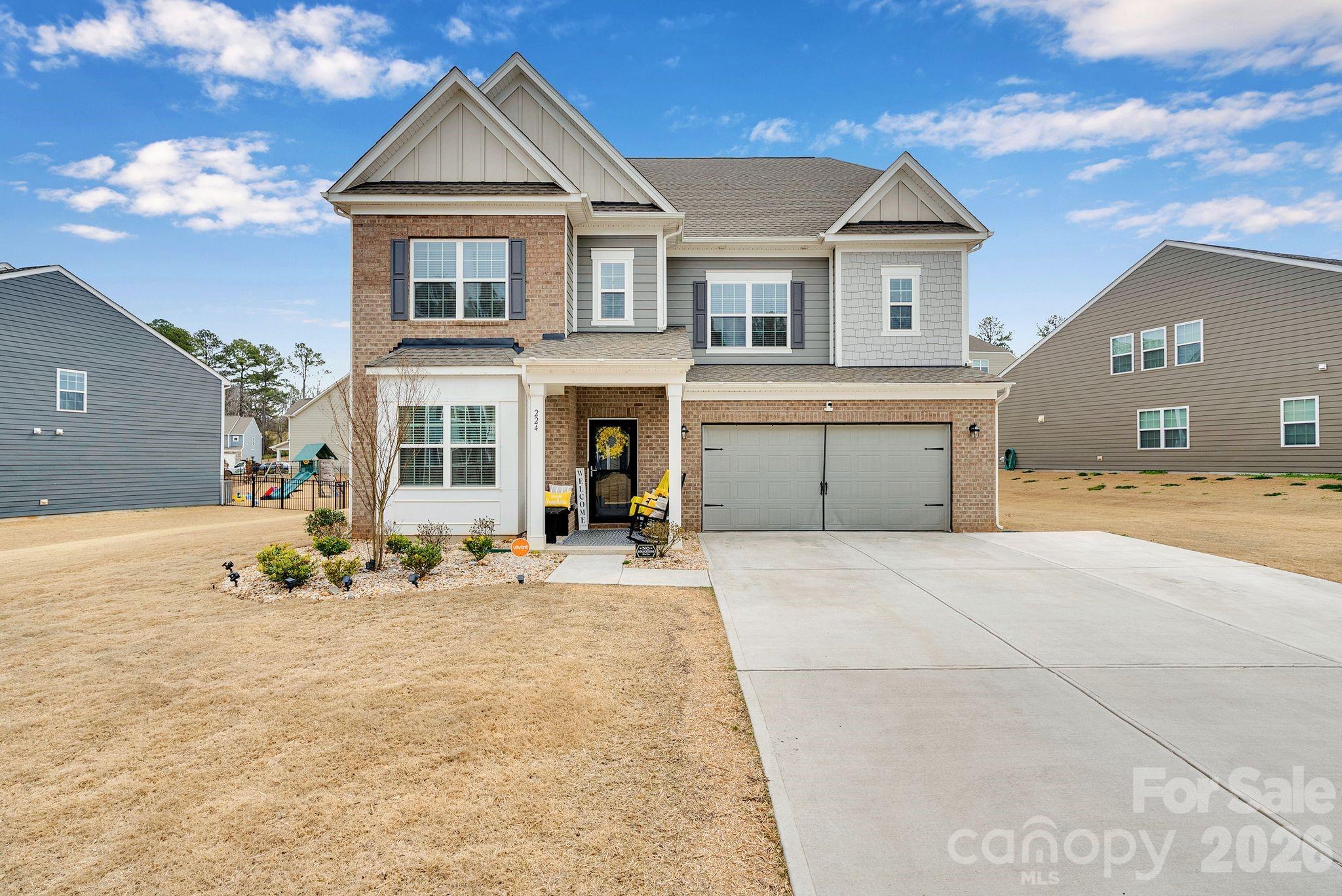 a front view of a house with a yard and garage