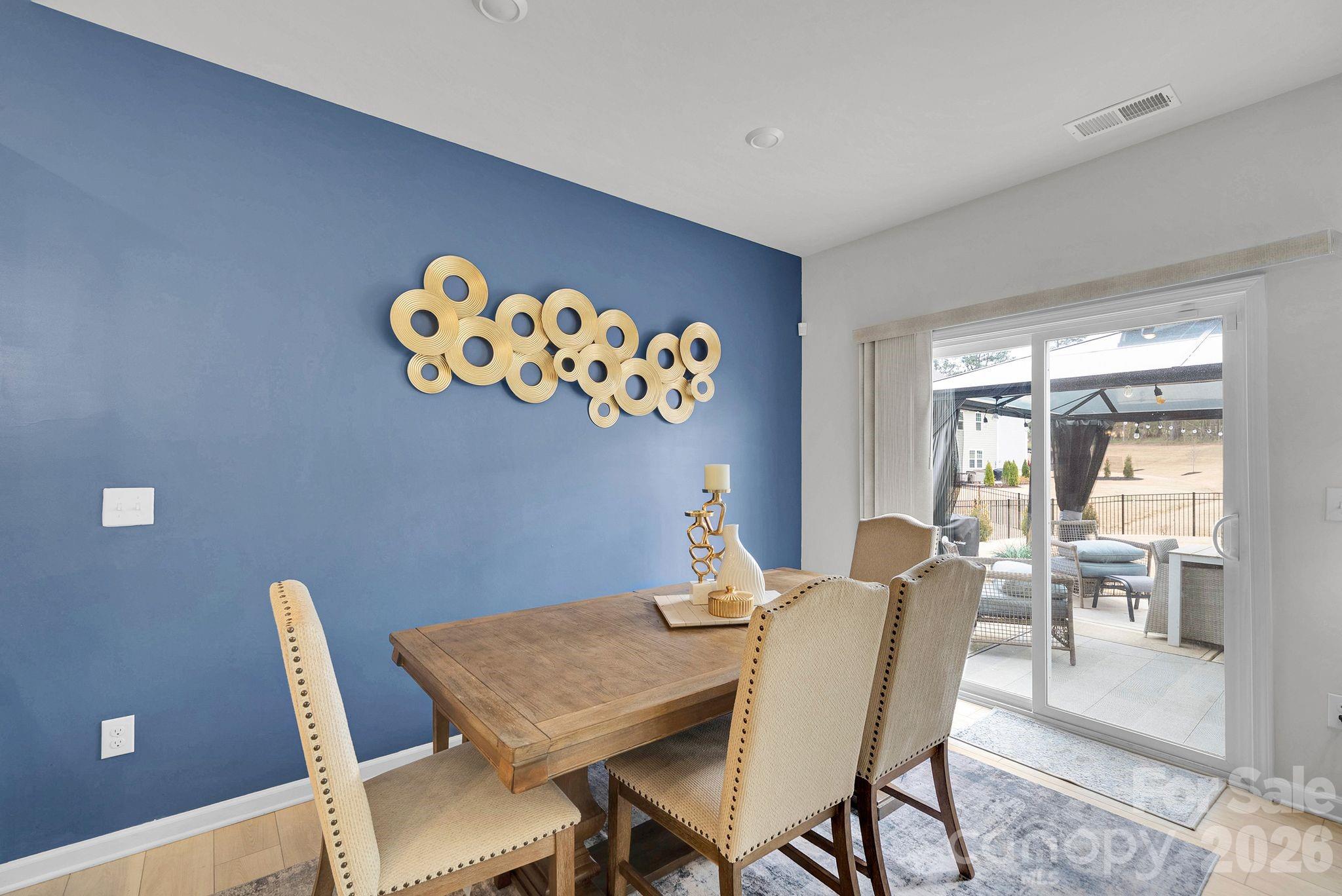 224 Hamptons Cove Road Troutman, NC 28166 - Photo 11 of 47 a view of a dining room with furniture and chandelier