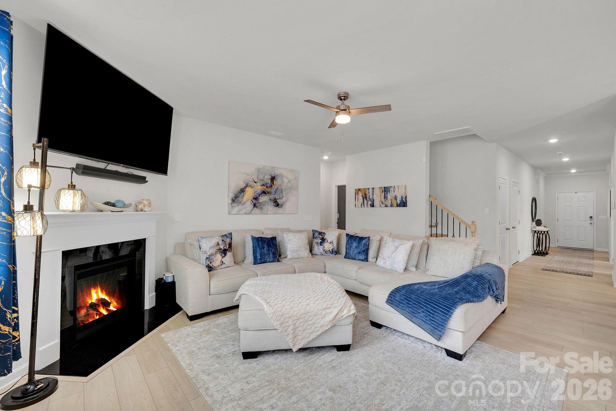224 Hamptons Cove Road Troutman, NC 28166 - Photo 12 of 47 a living room with furniture and a fireplace