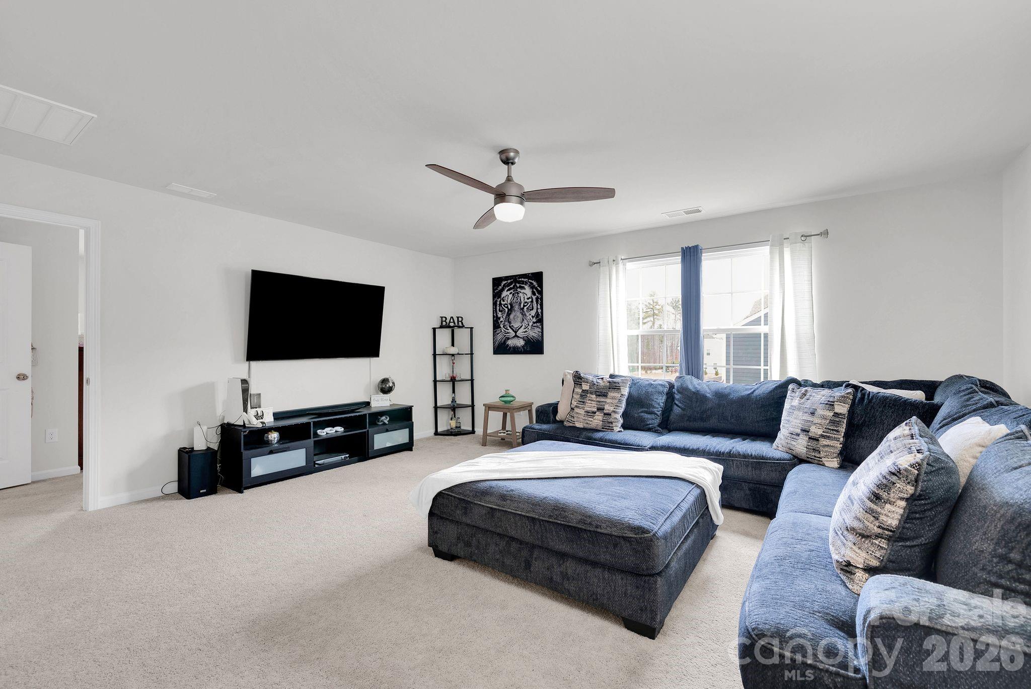 224 Hamptons Cove Road Troutman, NC 28166 - Photo 15 of 47 a living room with furniture and a flat screen tv
