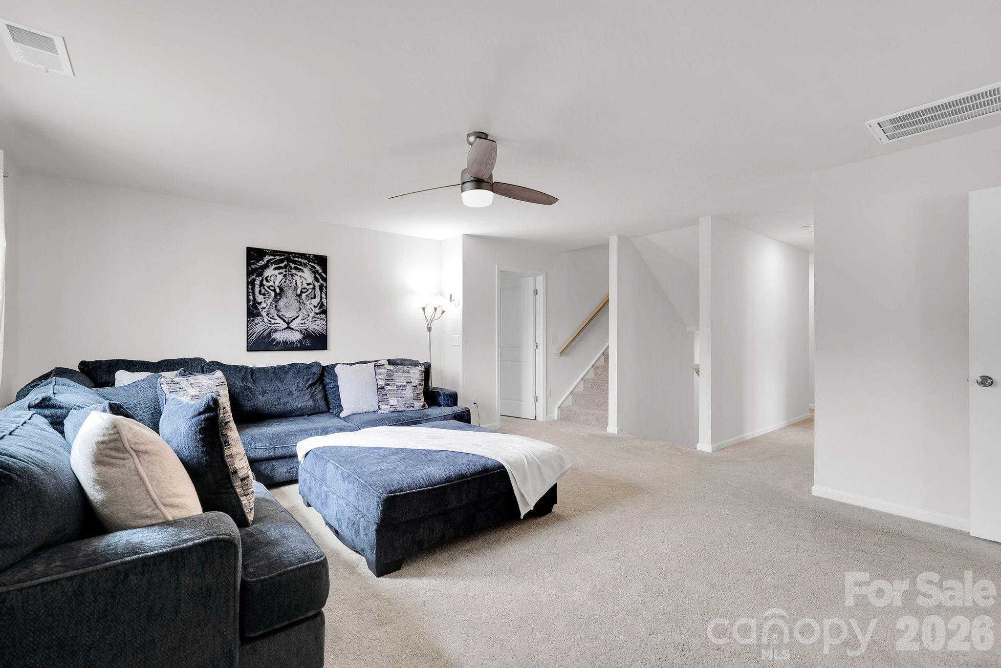 224 Hamptons Cove Road Troutman, NC 28166 - Photo 16 of 47 a spacious bedroom with a bed and a couch
