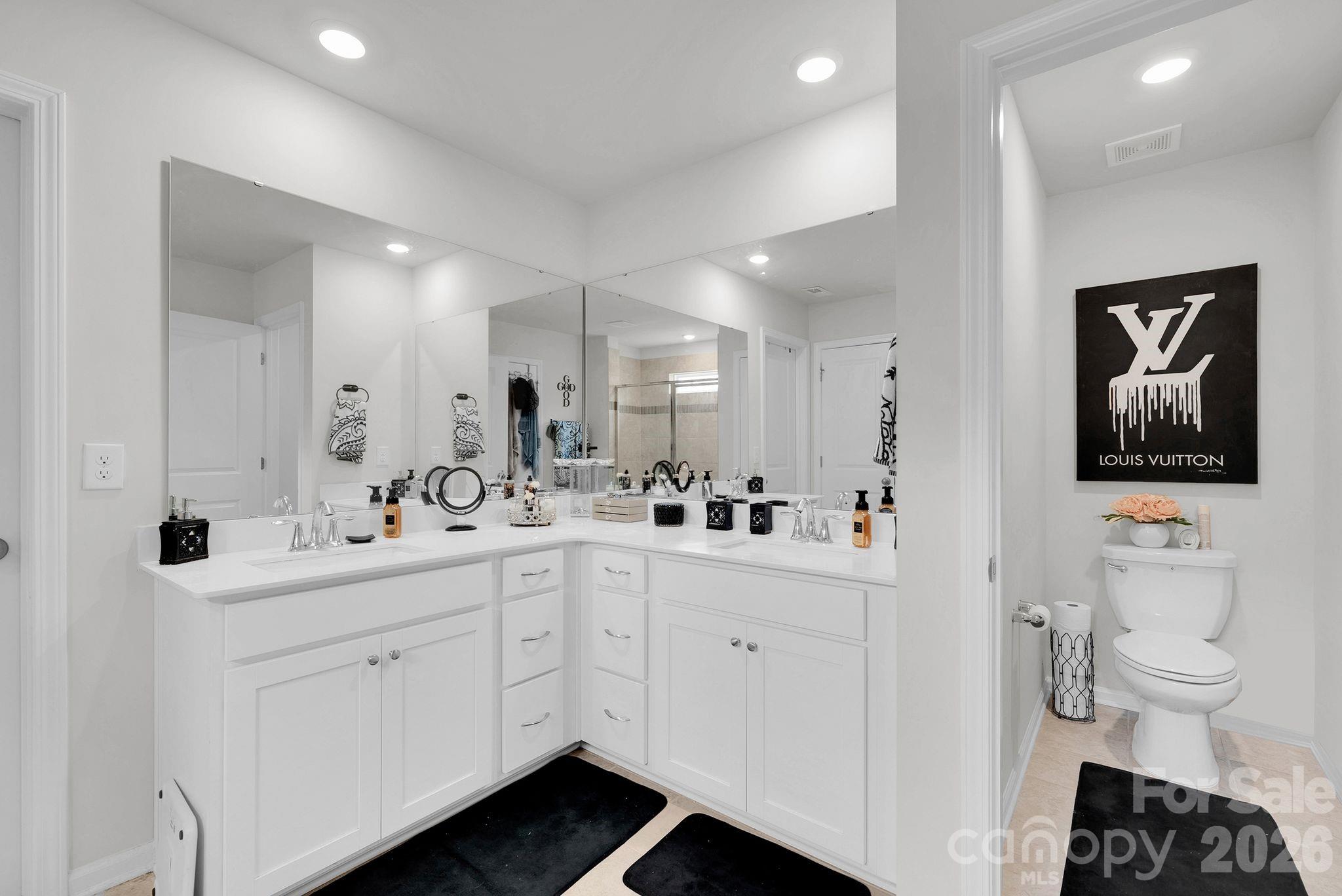 224 Hamptons Cove Road Troutman, NC 28166 - Photo 21 of 47 a bathroom with a double vanity sink mirror and toilet