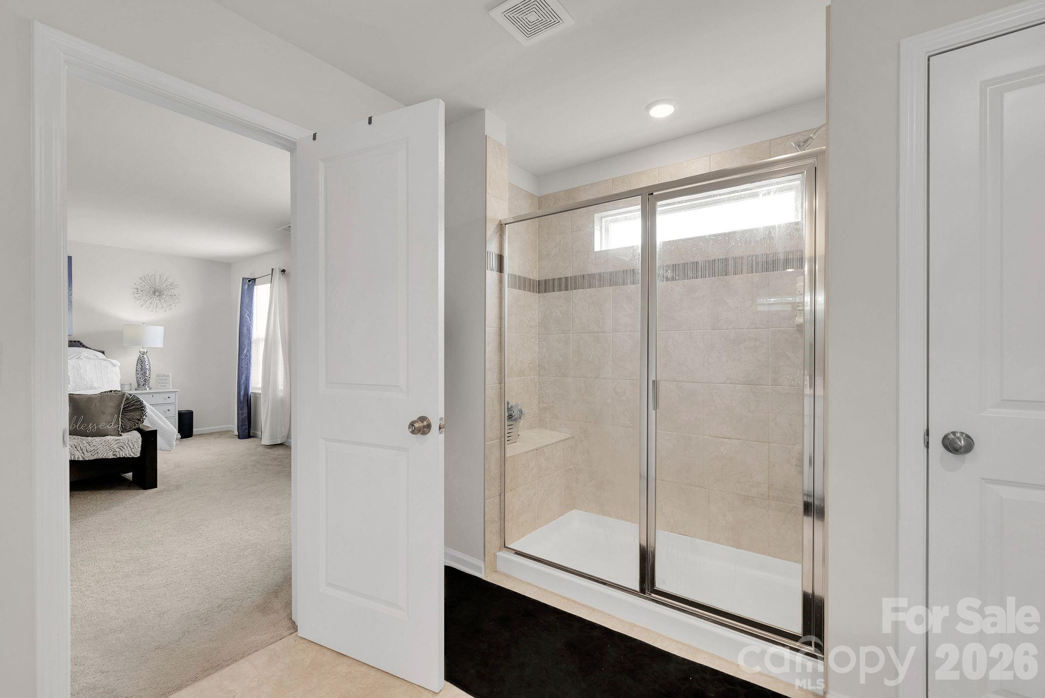 224 Hamptons Cove Road Troutman, NC 28166 - Photo 22 of 47 a view of a bathroom with a glass door shower