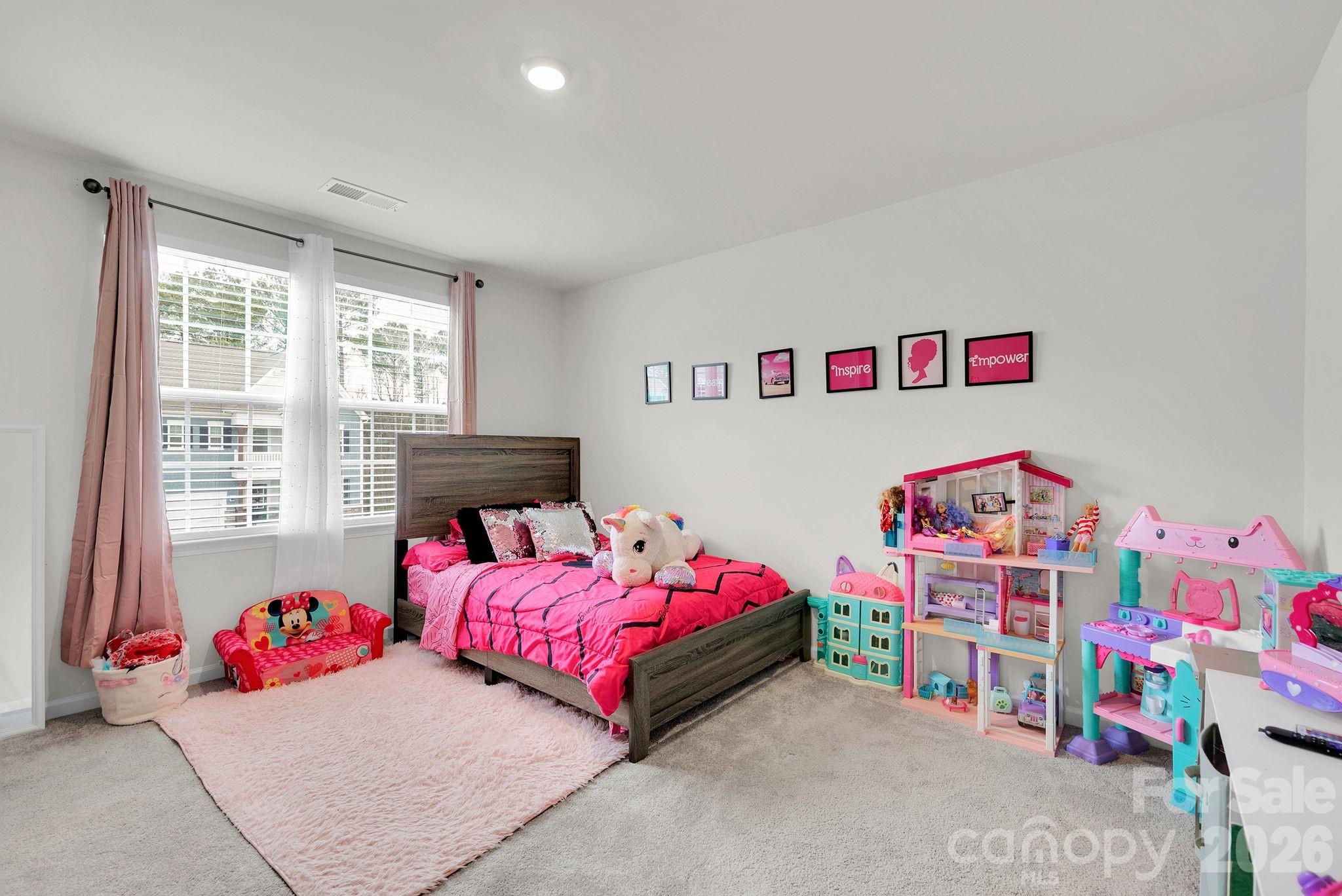 224 Hamptons Cove Road Troutman, NC 28166 - Photo 24 of 47 a bedroom with furniture and a window