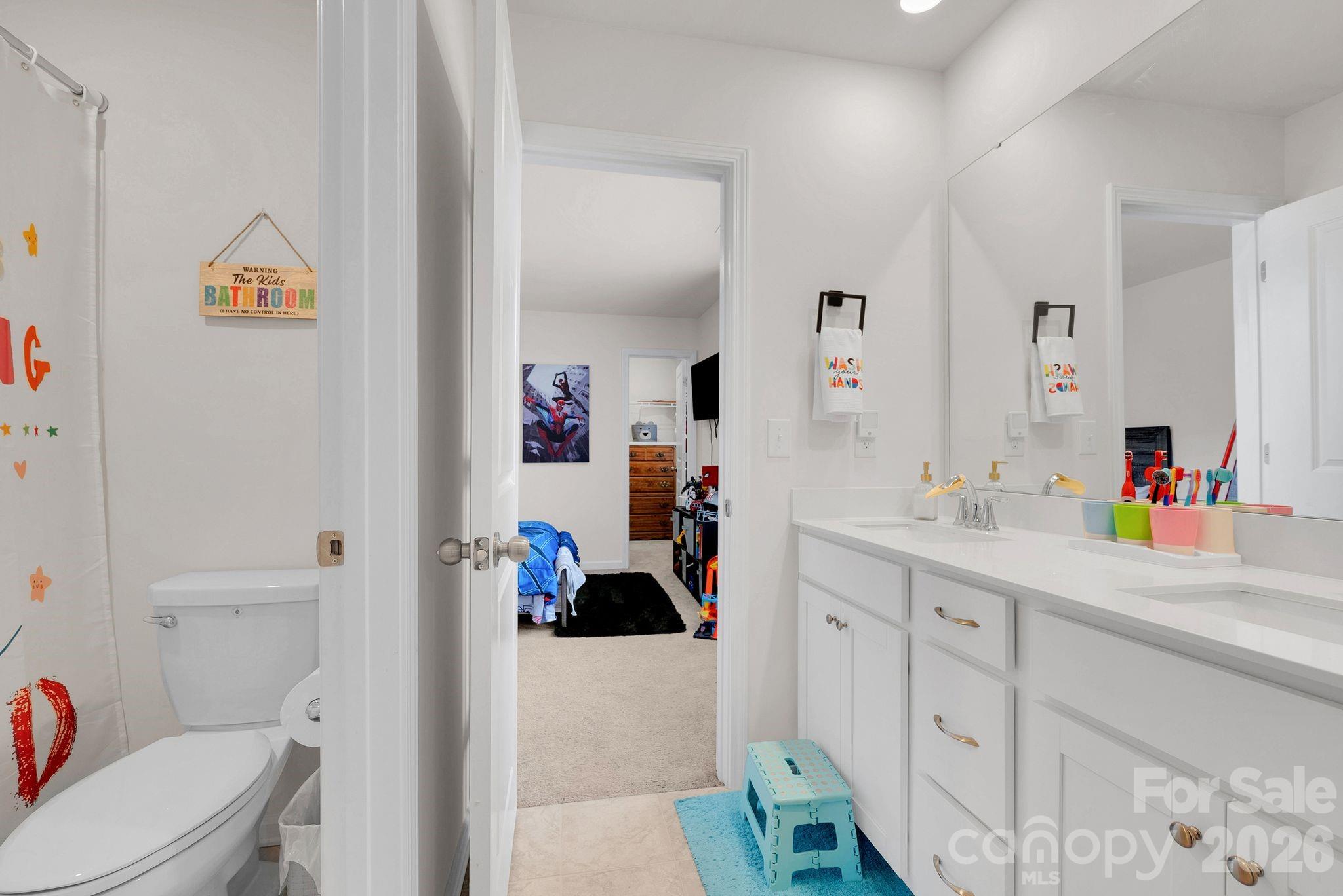 224 Hamptons Cove Road Troutman, NC 28166 - Photo 26 of 47 a bathroom with a sink a toilet and a mirror