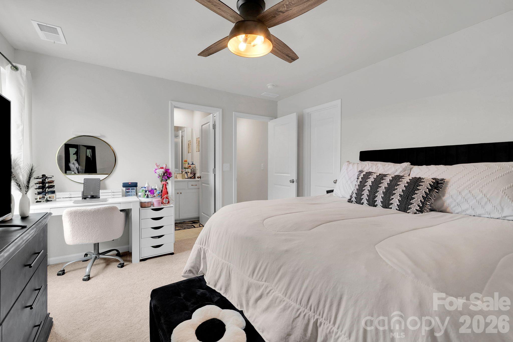 224 Hamptons Cove Road Troutman, NC 28166 - Photo 31 of 47 a bedroom with a bed and a chandelier