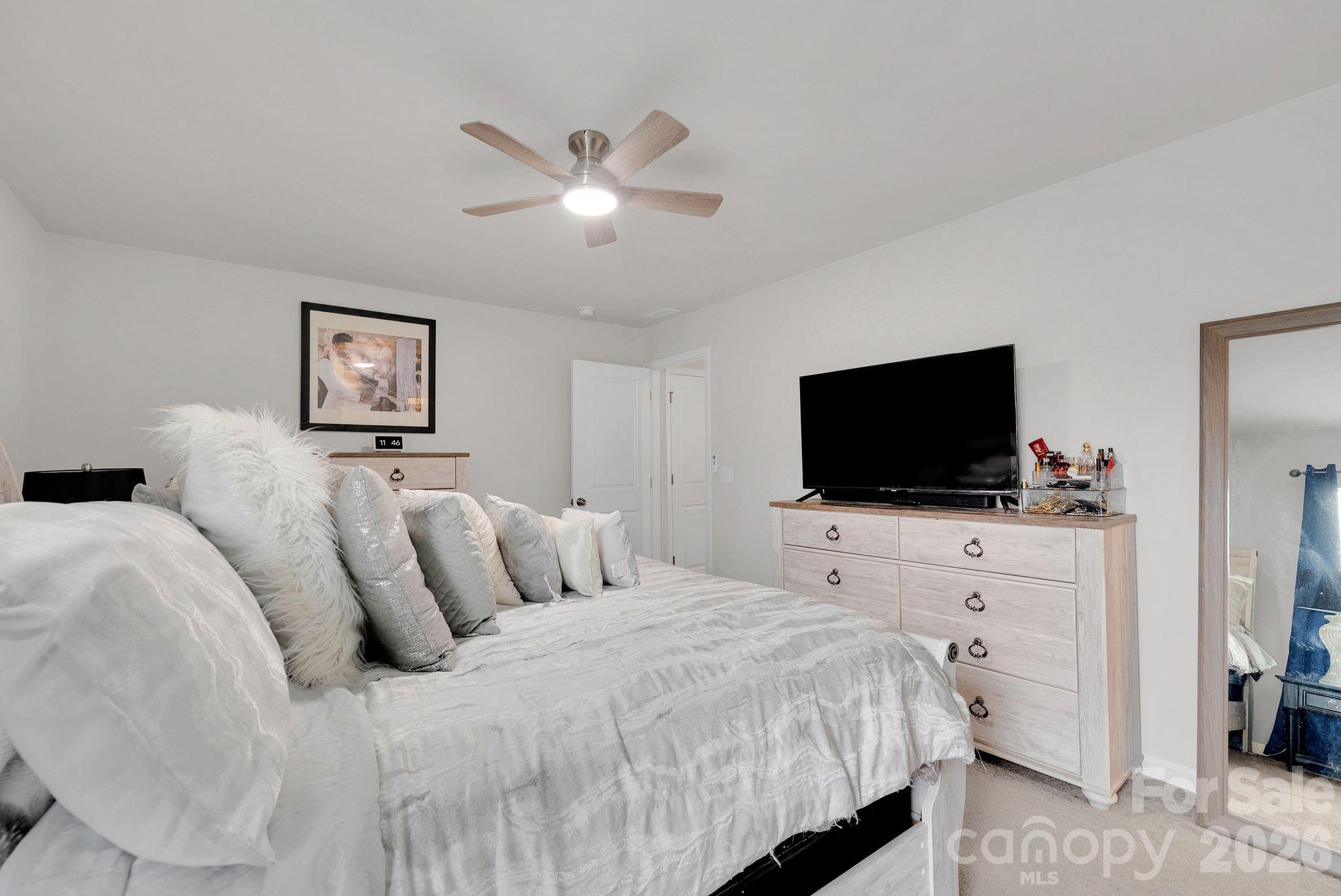 224 Hamptons Cove Road Troutman, NC 28166 - Photo 36 of 47 a bedroom with a bed and a flat screen tv