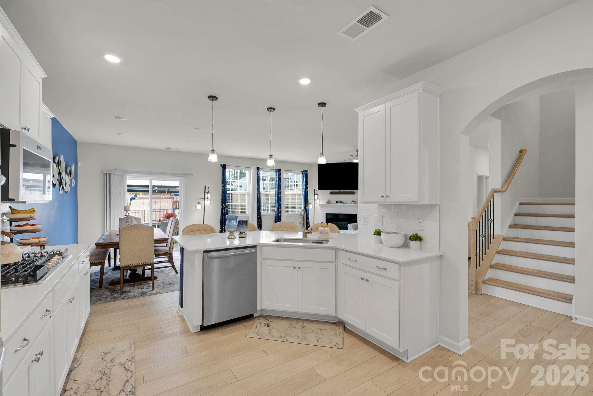 224 Hamptons Cove Road Troutman, NC 28166 - Photo 8 of 47 a kitchen with white cabinets and white appliances