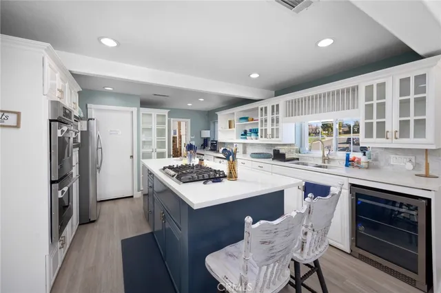 a kitchen with stainless steel appliances a sink stove and refrigerator