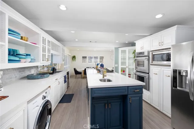 a open kitchen with stainless steel appliances granite countertop a sink stove and refrigerator