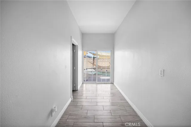 a view of a hallway with wooden floor