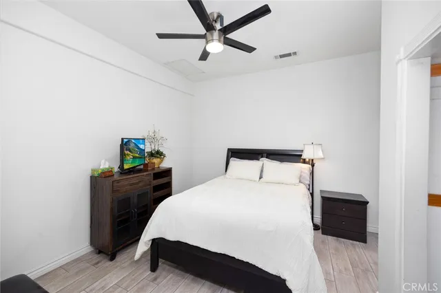 a bedroom with a bed and a tv