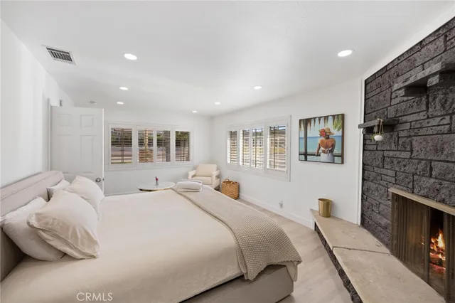 a bedroom with a bed and a fireplace