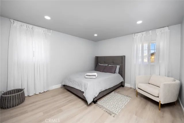 a bedroom with a bed and a couch