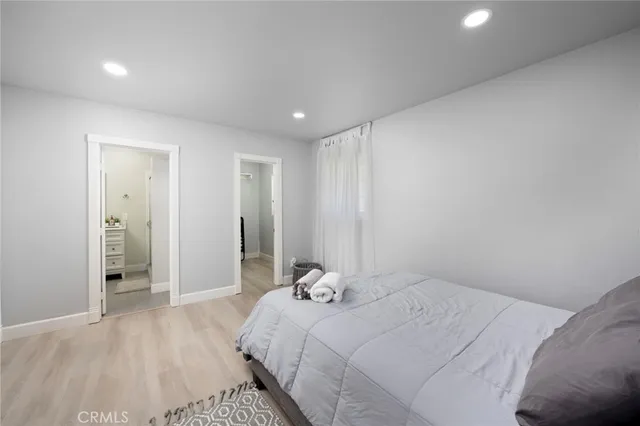 a bedroom with a bed and a walk in closet