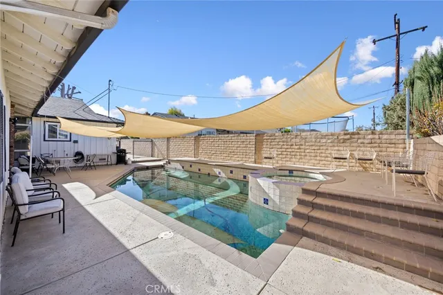 a view of a swimming pool with a patio