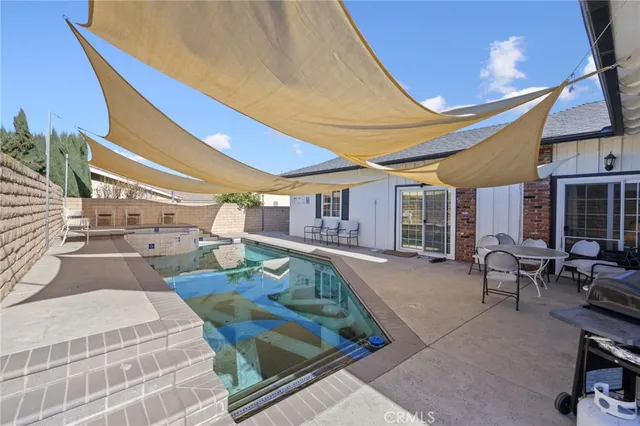 a swimming pool with outdoor seating and yard