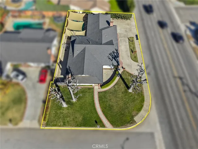 an aerial view of a house with a yard