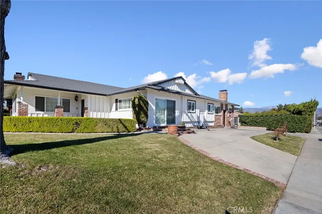 a view of a house with swimming pool and sitting area