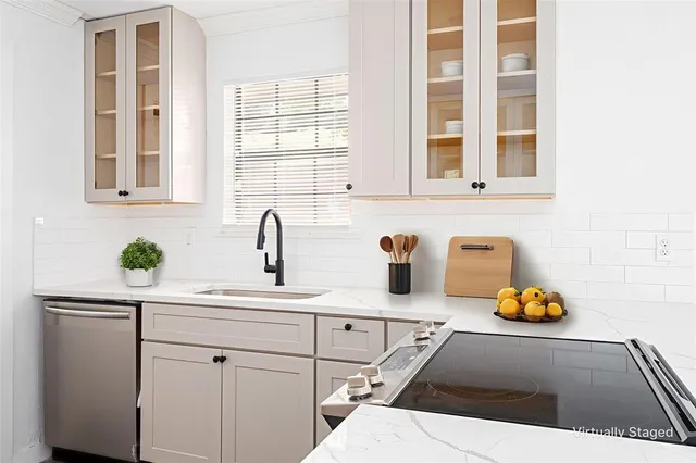 a kitchen with a sink and a white wooden cabinets