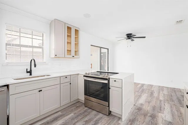 a kitchen with a stove oven and sink