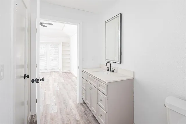 a bathroom with a sink a toilet and a mirror