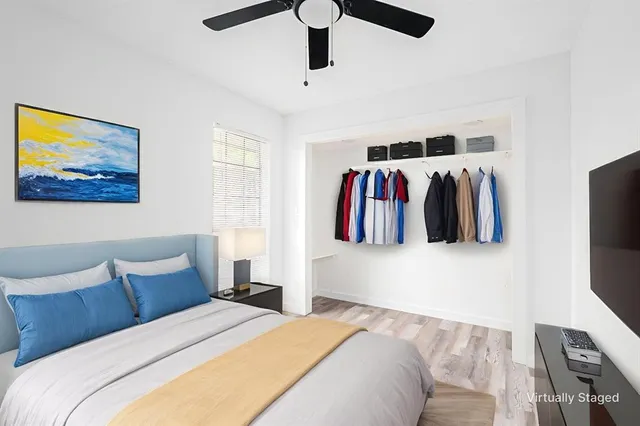 a bedroom with a bed and a flat screen tv