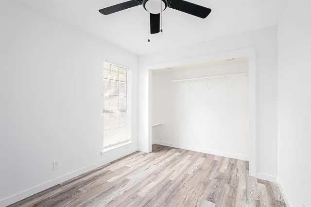 a view of empty room with wooden floor