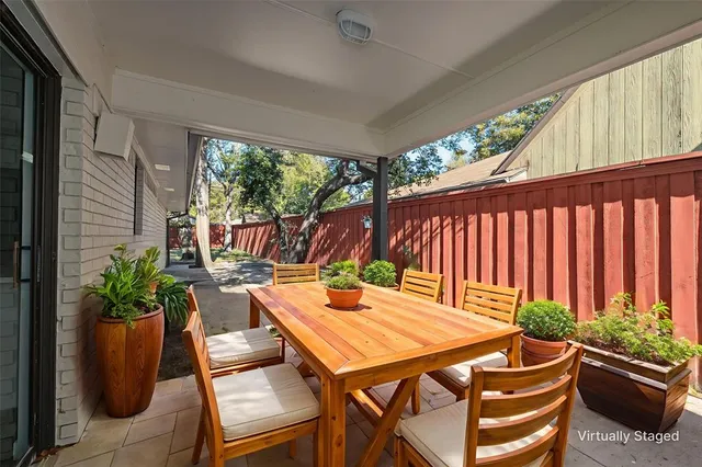a outdoor dining space with furniture and potted plants