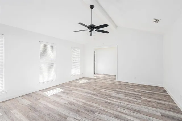 a view of a livingroom with a ceiling fan and window
