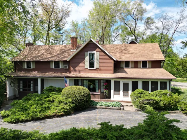 a kitchen with stainless steel appliances granite countertop a refrigerator a sink dishwasher a stove with wooden cabinets and floor