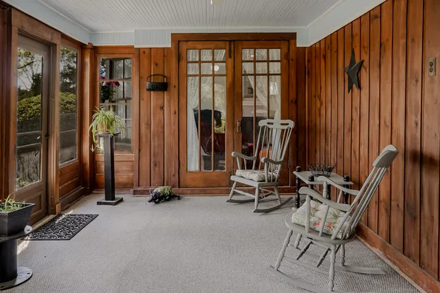 a view of a livingroom with furniture and floor to ceiling window