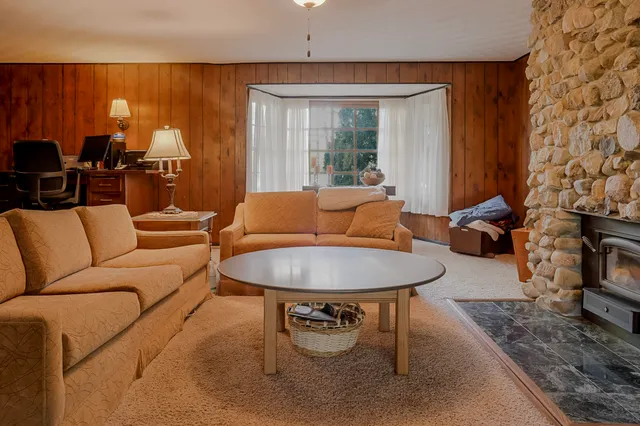 a living room with furniture and a fireplace