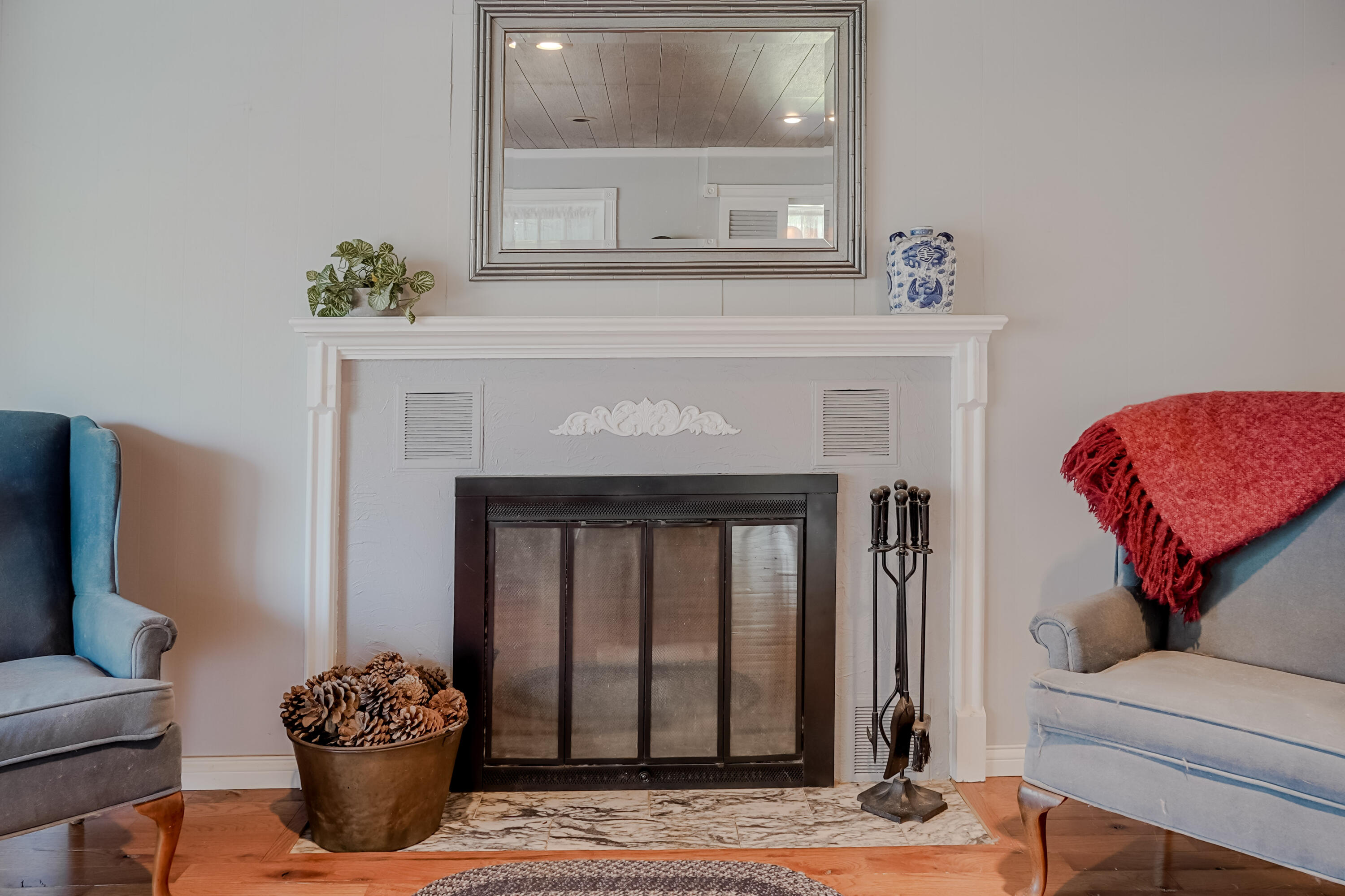9014 East 129th Avenue Crown Point, IN 46307 - Photo 32 of 56 a living room with a fireplace and a potted plant