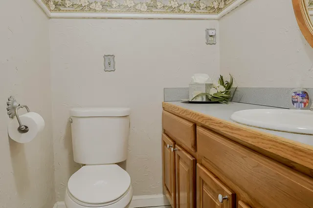 a kitchen with a sink cabinets and wooden floor
