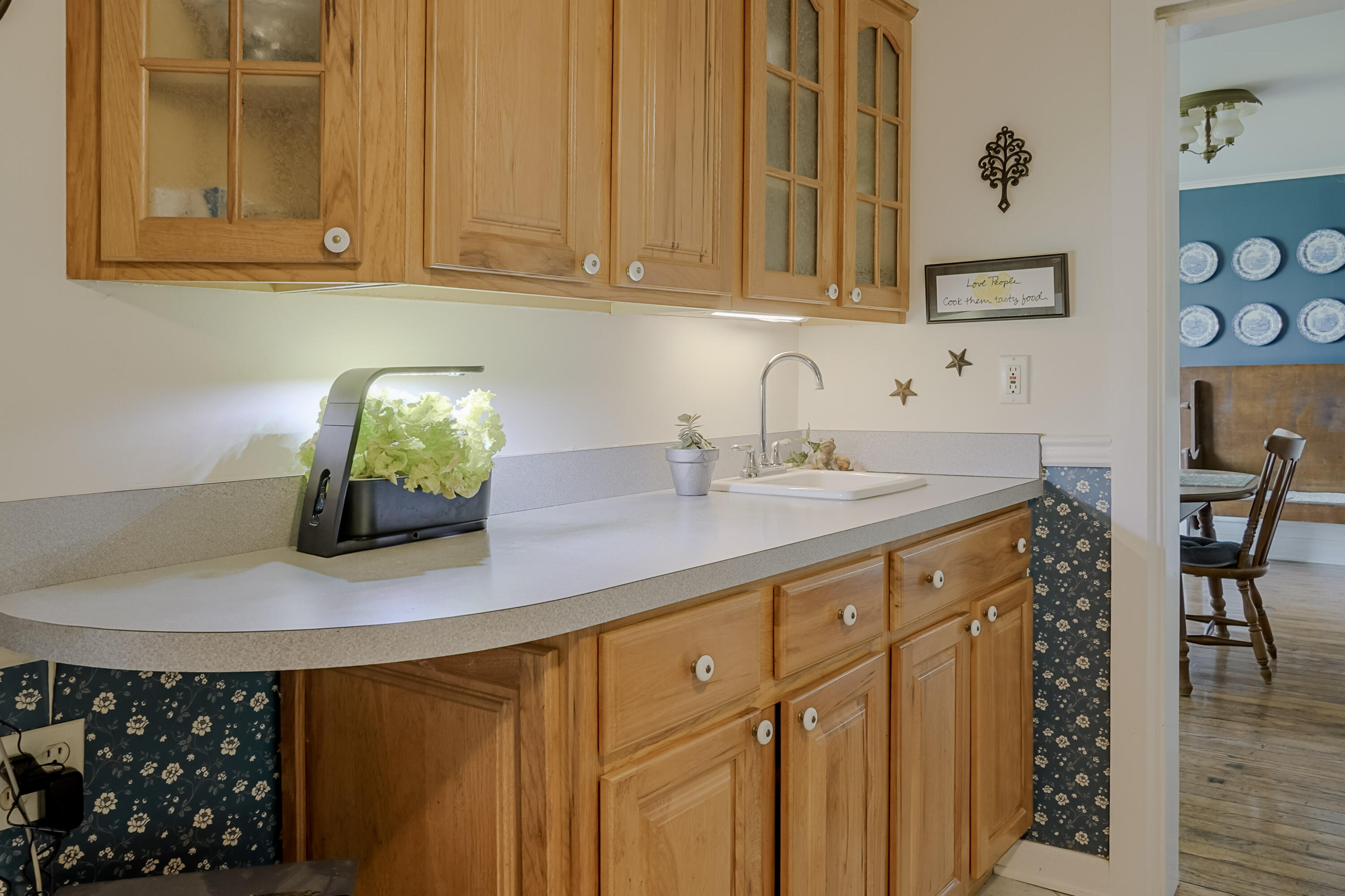 9014 East 129th Avenue Crown Point, IN 46307 - Photo 35 of 56 a kitchen with a sink cabinets and wooden floor