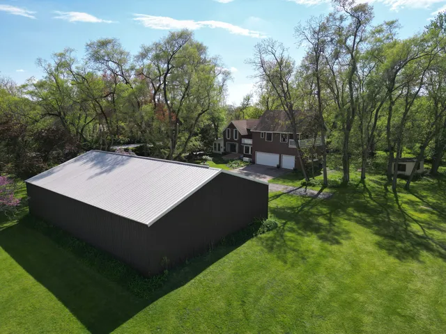 an aerial view of a house with a yard