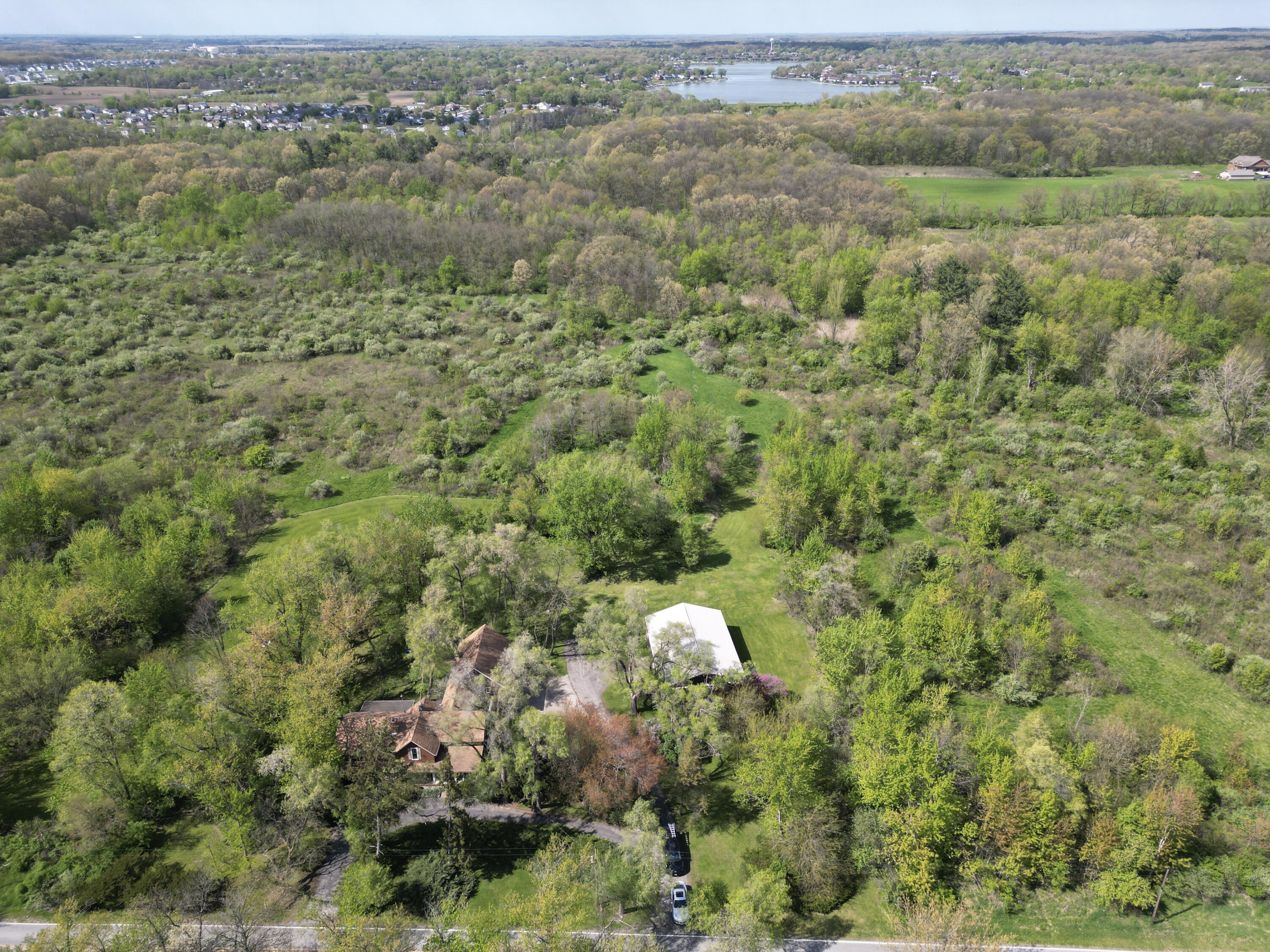 9014 East 129th Avenue Crown Point, IN 46307 - Photo 51 of 56 an aerial view of a houses with a lush green hillside