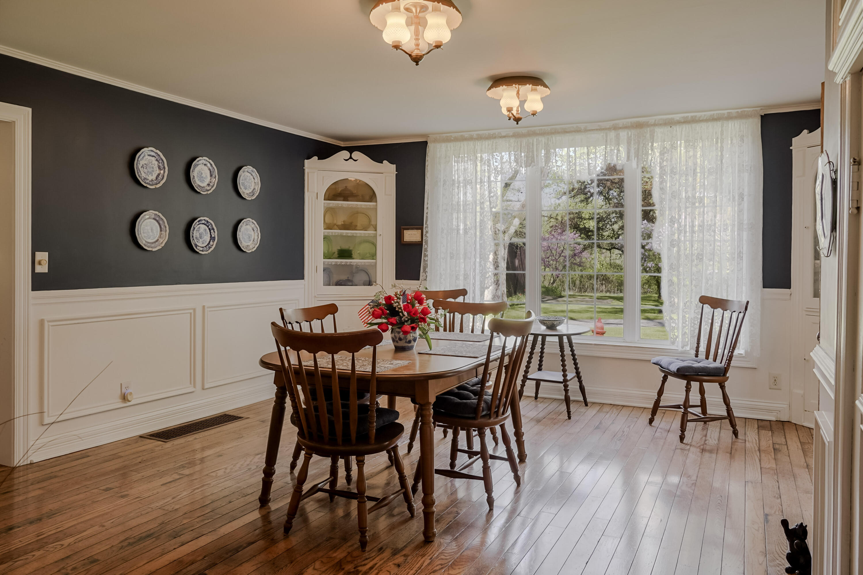 9014 East 129th Avenue Crown Point, IN 46307 - Photo 9 of 56 a view of a dining room with furniture window and wooden floor