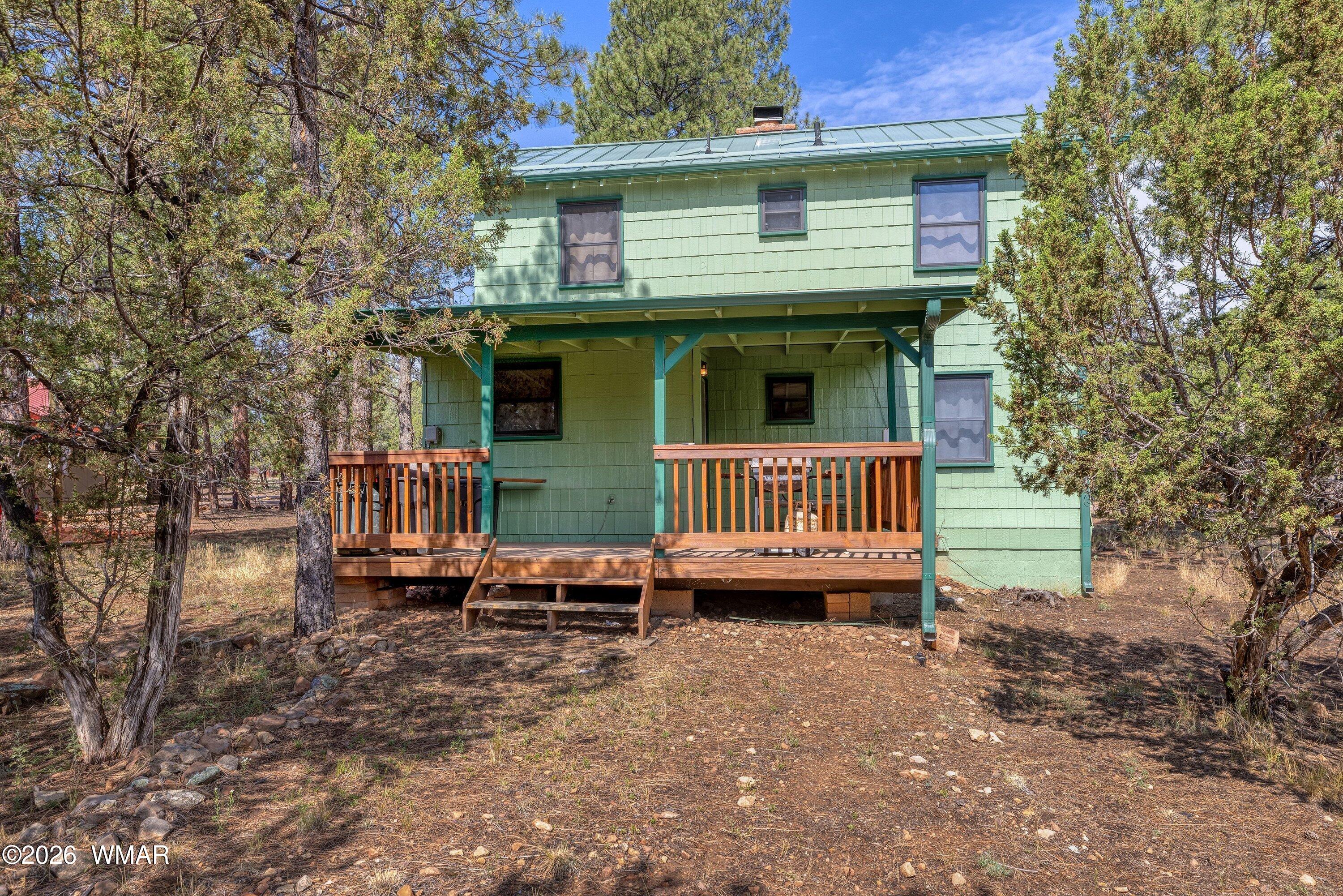3307 Pine Ridge Drive Overgaard, AZ 85933 - Photo 17 of 24 a view of a house with a yard and deck