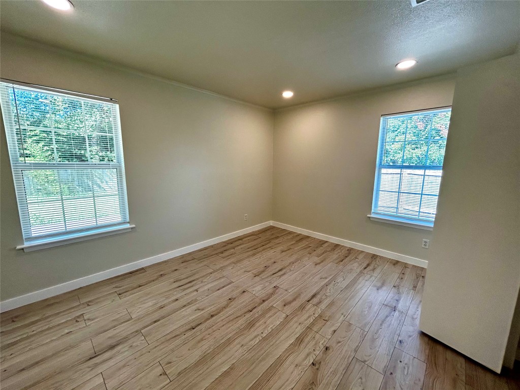 1005 West Martin Luther King Jr Boulevard Austin, TX 78701 - Photo 16 of 31 Spare room with recessed lighting and light wood-style floors
