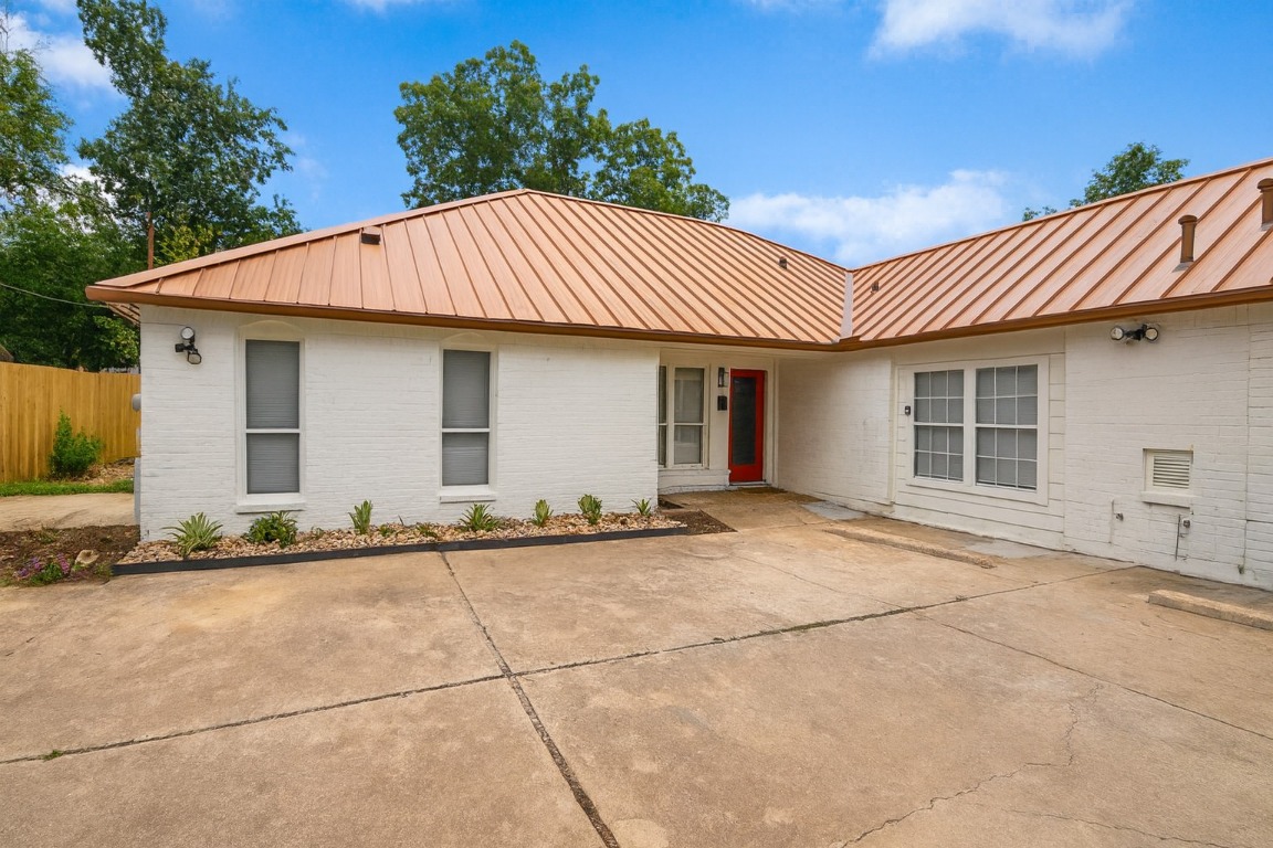 1005 West Martin Luther King Jr Boulevard Austin, TX 78701 - Photo 2 of 31 Single story home with a standing seam roof, a metal roof, and brick siding