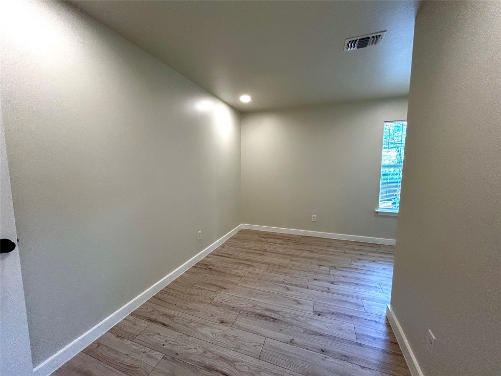 1005 West Martin Luther King Jr Boulevard Austin, TX 78701 - Photo 26 of 31 Empty room with light wood finished floors and recessed lighting