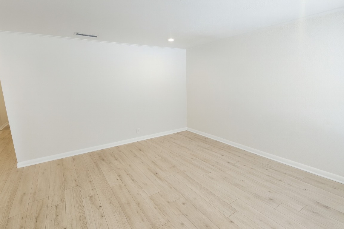 1005 West Martin Luther King Jr Boulevard Austin, TX 78701 - Photo 5 of 31 Unfurnished room with light wood finished floors and recessed lighting