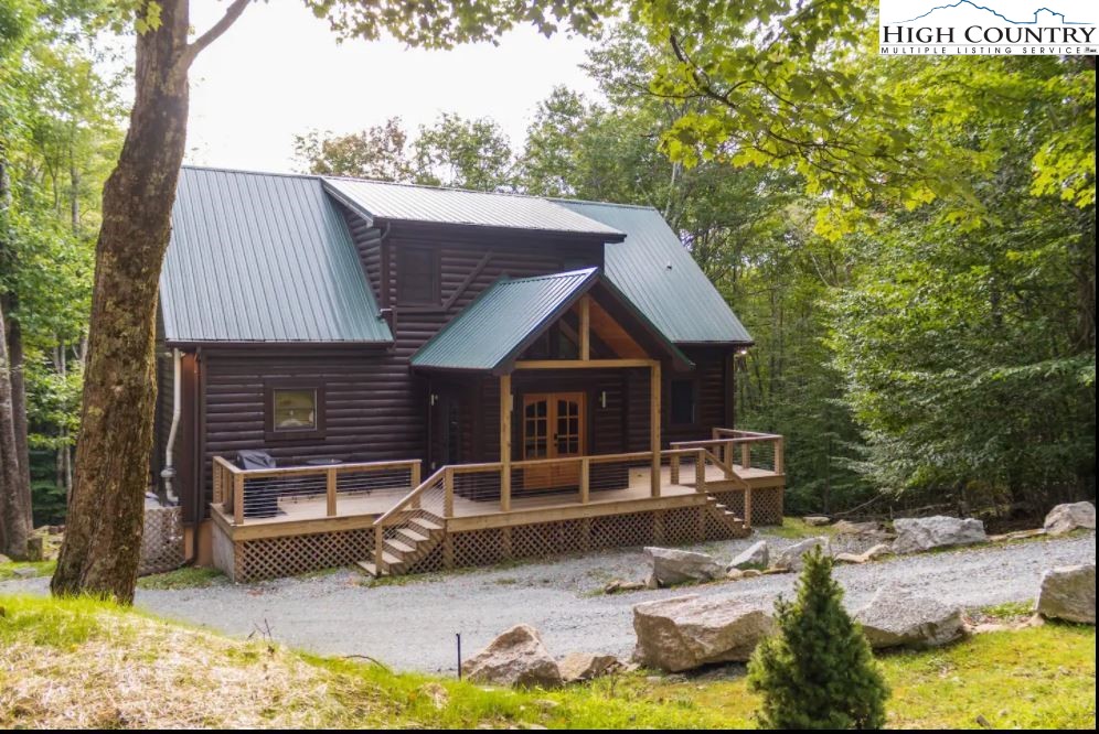 a view of backyard with deck and seating area