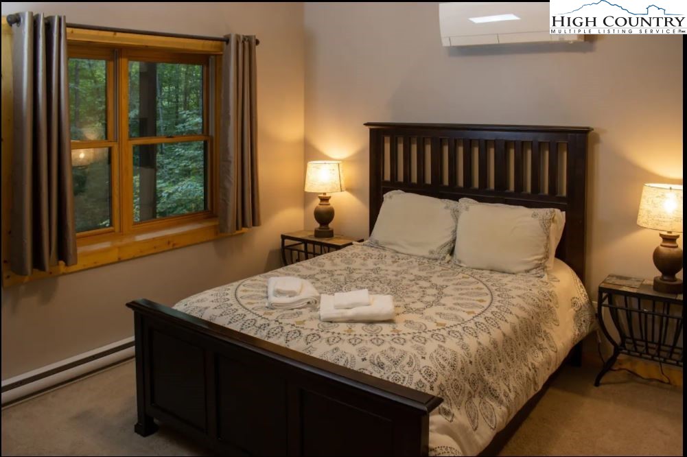 124 Aster Trail Beech Mountain, NC 28604 - Photo 15 of 26 a bedroom with a bed and window