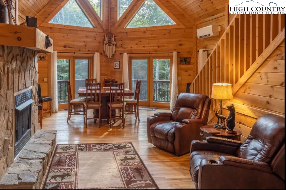 124 Aster Trail Beech Mountain, NC 28604 - Photo 2 of 26 a living room with furniture a fireplace and large windows