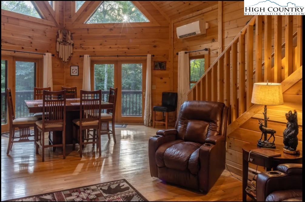 124 Aster Trail Beech Mountain, NC 28604 - Photo 4 of 26 a living room with furniture and a floor to ceiling window
