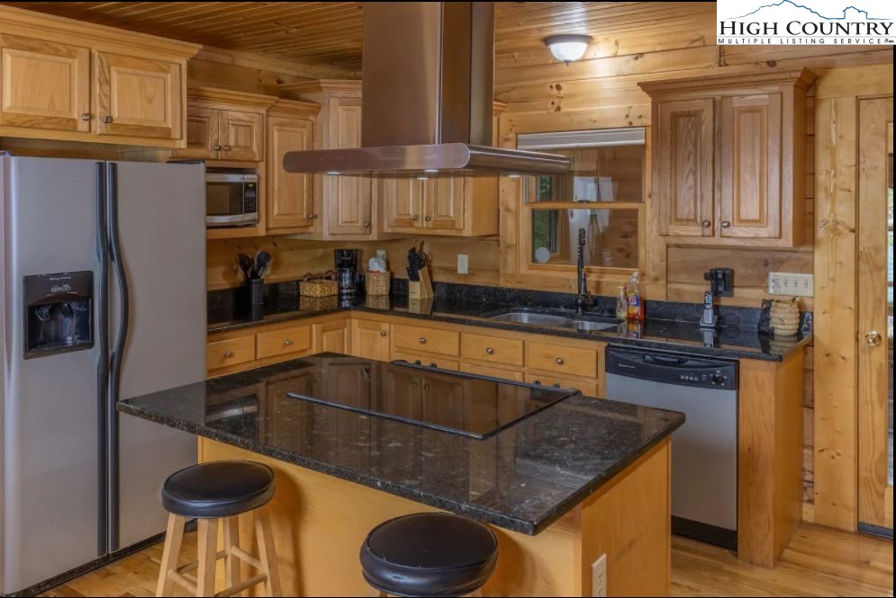 124 Aster Trail Beech Mountain, NC 28604 - Photo 6 of 26 a kitchen with stainless steel appliances granite countertop a sink a stove and a refrigerator